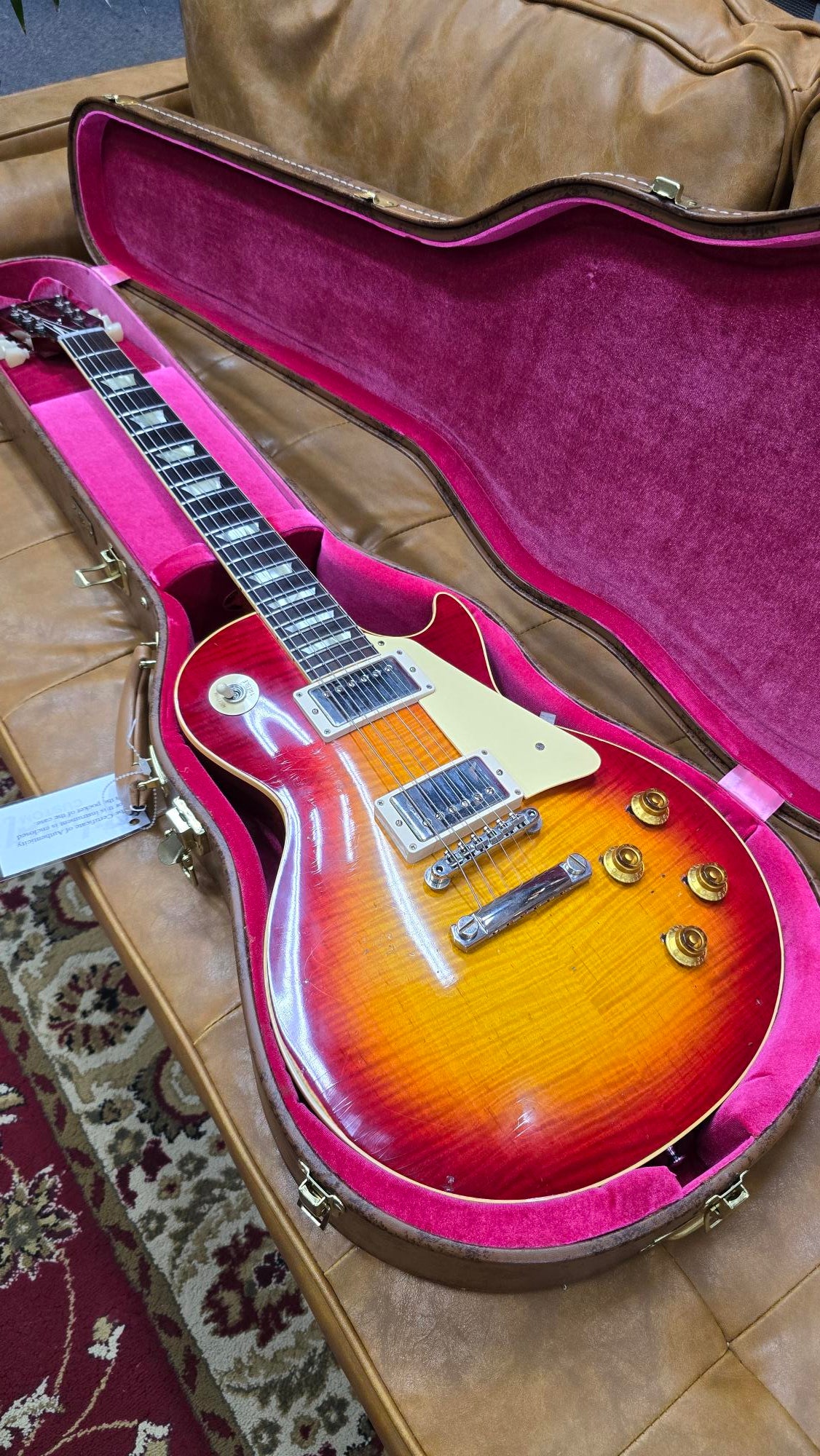 Gibson Les Paul electric guitar in Washed Cherry Burst finish, displayed in its case.