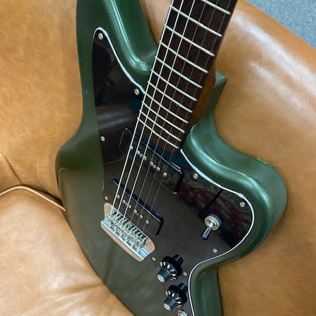 Green Custom Jazzmaster on a brown leather couch