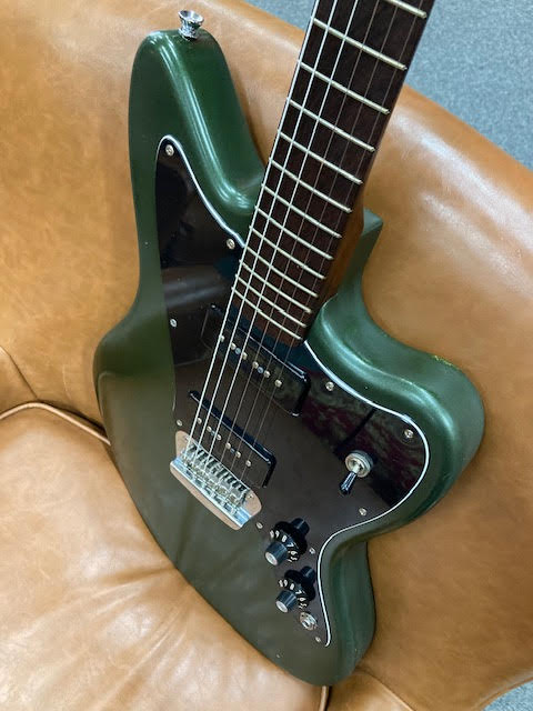 Green Custom Jazzmaster on a brown leather couch