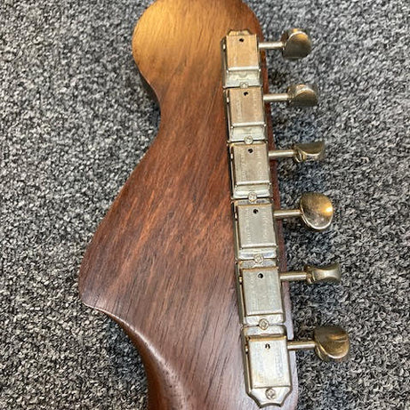 Custom Green Jazzmaster guitar Rosewood headstock with Grover Deluxe tuning pegs on a textured gray surface