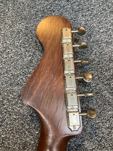 Custom Green Jazzmaster guitar Rosewood headstock with Grover Deluxe tuning pegs on a textured gray surface